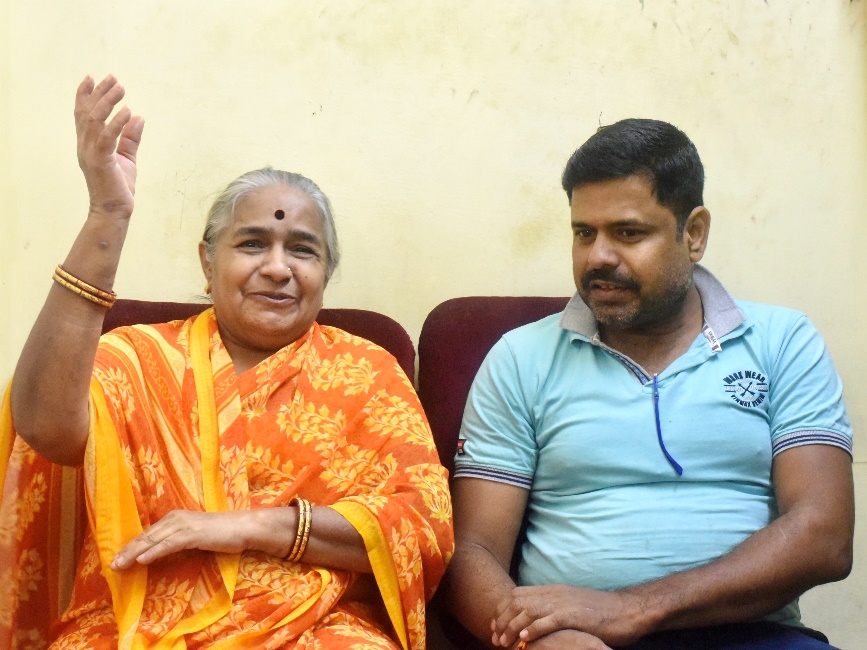 Patient and family member smiling and celebrating restored sight.